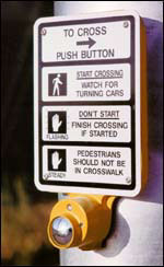 Push button activated crosswalk warning flash